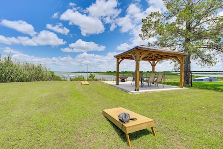 A gazebo with a table and chairs, a grassy lawn, and a view of the water.. Cabin w/ Dock on Hubbard Creek Lake: Pets Welcome!