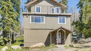 A two-story cabin with a balcony, a front porch, and a small attached shed. - Hike, Ski & Explore! Spacious Home in Twin Bridges (Echo Lake)