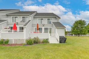 A two-story house with a covered porch, a red umbrella, and a grill. - Pool Access & 2 Mi to Beach! Ocean City Escape (Ocean City)