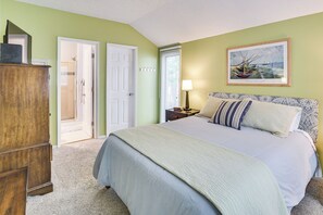 A bedroom with a bed, a wooden wardrobe, a door, a window, and a wall-mounted picture. - Only 8/22-8/29 Still Available for Summer 2026! (Harbor Springs)