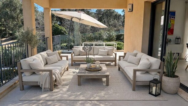 A sunlit patio with a beige sofa set, a coffee table, and a large umbrella. - Spacious 5-bedroom house with AC and Pool (Le Plan-de-la-Tour)