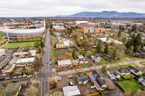 An aerial view of a cityscape with a stadium, residential areas, and commercial buildings. - Hayward Field Studio. In the heart of Tracktown USA. (Eugene)