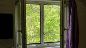 A room with a window, a purple curtain, and a bed. - Lychenlodge on Oberpfuhl Lake with canoe & fireplace (Lychen)