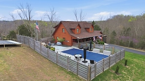 A log cabin with a swimming pool, deck, and outdoor seating area. - The Lodge @ Lake Cumberland  
For Families and Friends! (Jamestown)