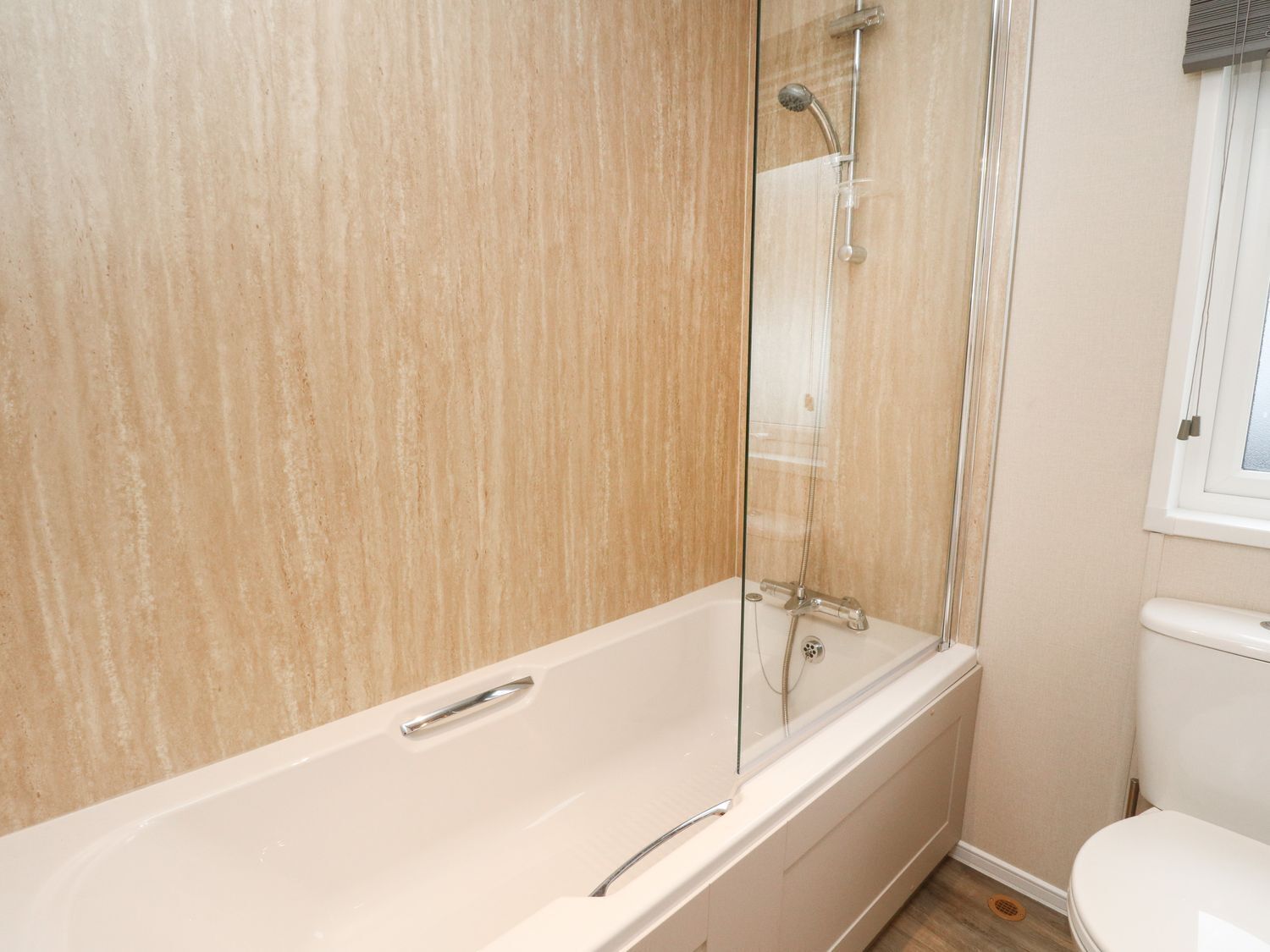 A bathroom with a bathtub, a shower, and a toilet.