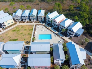 A resort with multiple buildings, a central swimming pool, and a landscaped area with lounge chairs. - ☀️ Gated Community - 2 Pools - Barefoot Cottage B28 🌴 (Port St. Joe)
