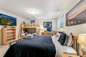A bedroom with bunk beds, a desk, a TV, and a bookshelf. - 1200w21 The Mountain Condo 2 Bedroom Condo (South Lake Tahoe)