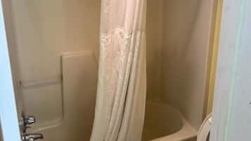 Bathtub, towels, soap, shampoo