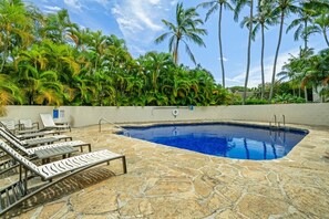 A swimming pool with lounge chairs and palm trees. - Kauai Kahala At Poipu Kai 212 1 Bedroom Condo (Koloa)
