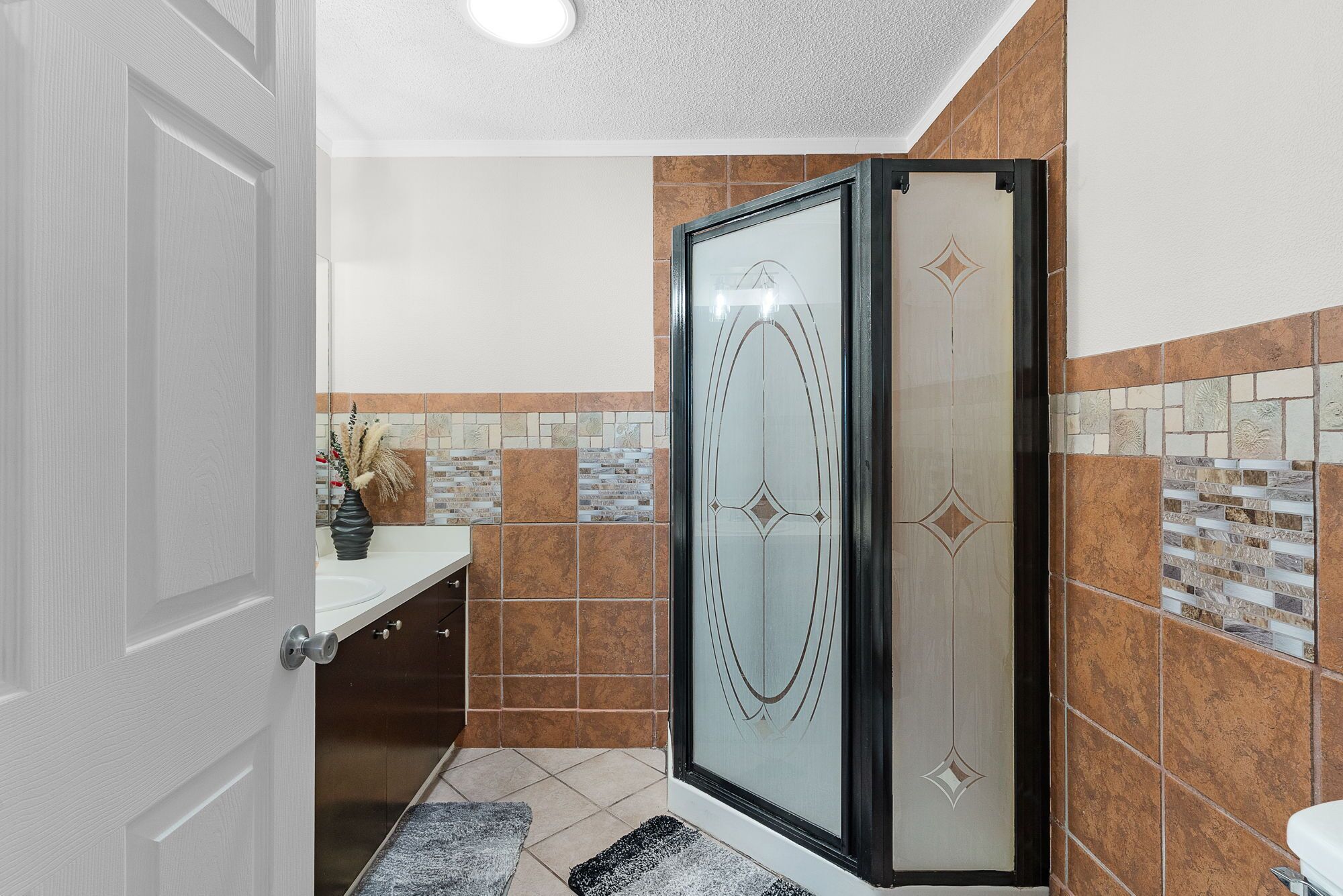 Une salle de bain avec une douche, un lavabo et des toilettes.