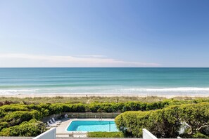 A pool with a view of the ocean and beach. - Coral Shores #12 - Oceanfront Condo (Pine Knoll Shores)