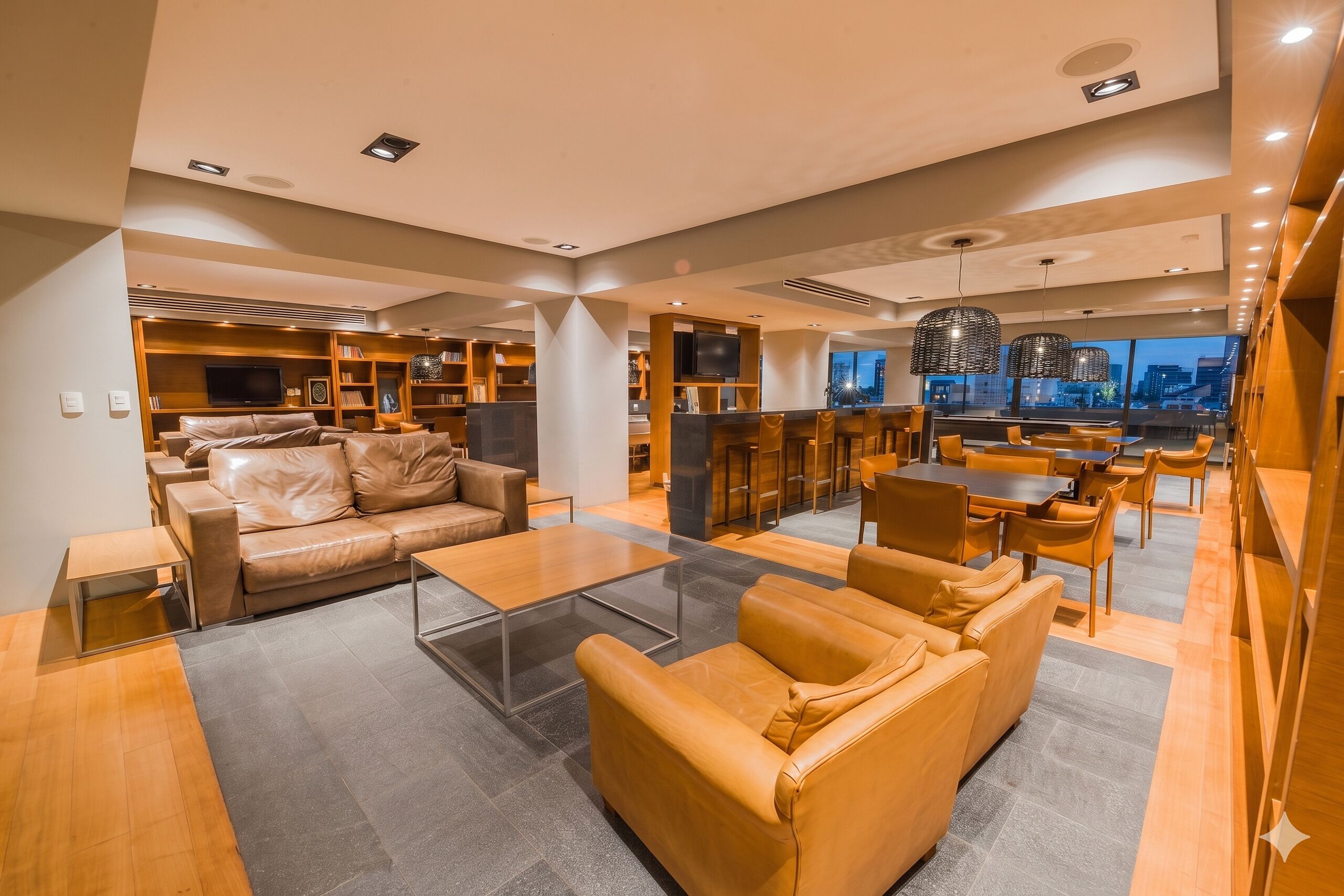 A modern living area with a leather sofa, a glass coffee table, and a dining area with wooden furniture.