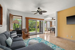 A spacious living area with a sofa, a chair, a table, and a ceiling fan. - New Listing! Kahala Poipu Kai 212, Great Location (KOLOA)