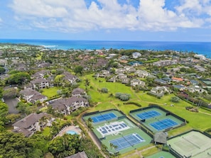 An aerial view of a residential area with houses, green spaces, and tennis courts. - New Listing! Kahala Poipu Kai 212, Great Location (KOLOA)