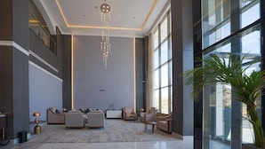A spacious lobby with a high ceiling, modern furniture, and large windows. - Grand Iva Hotel Abha (Abha)