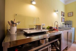A modern kitchen with stainless steel appliances, a sink, and a countertop with utensils. - Charming Venetian  Retreat-3 Bedrooms, Dorsoduro (Venezia)