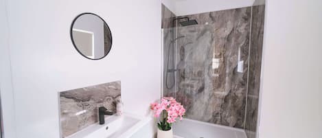 Shower, hair dryer, towels, shampoo