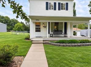 A two-story house with a porch, number 530, and a small garden area.