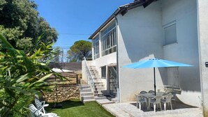 A house with a patio, outdoor furniture, and a staircase leading to a second floor. - Apartment with pool and garden (Boisset-et-Gaujac)