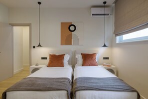 A double room with two beds, a wall-mounted artwork, a ceiling fan, and a window with a blind. - Sunny Central Retreat with Private Plunge Pool (Athina)