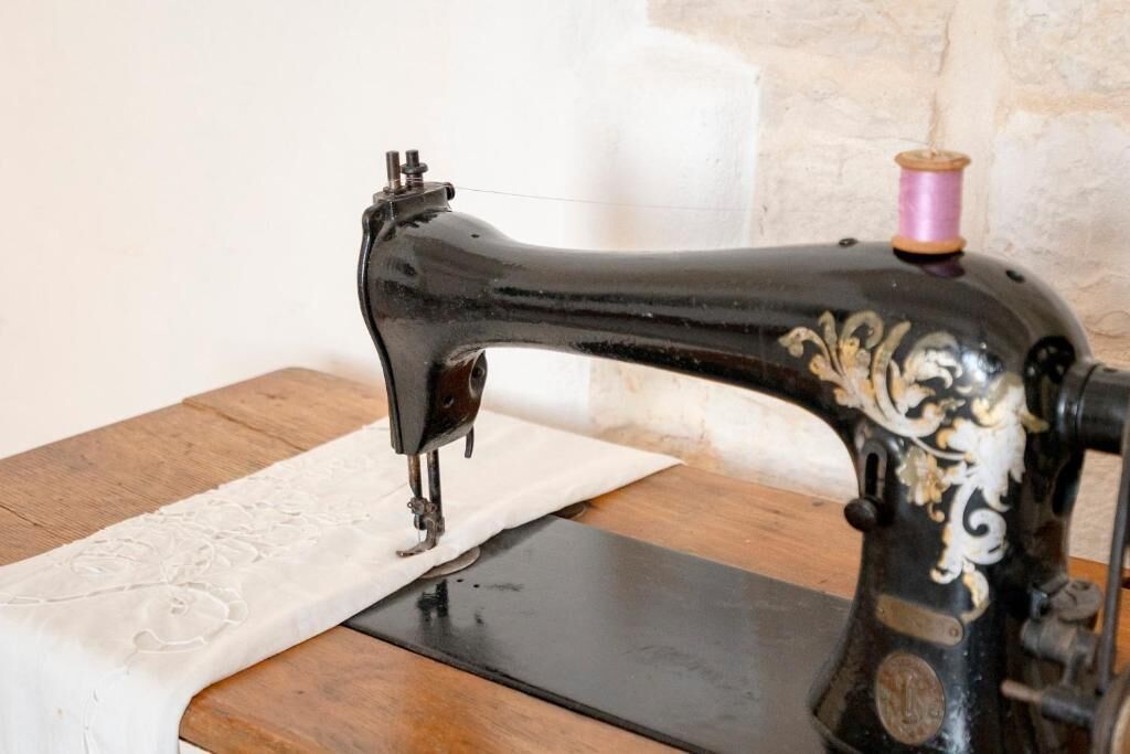 A vintage sewing machine on a wooden table.