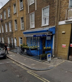 A blue storefront with a contact number, a 'No Parking' sign, and a 'OPEN' sign. - Comfortable Double Room with Ensuite - R4 (London)