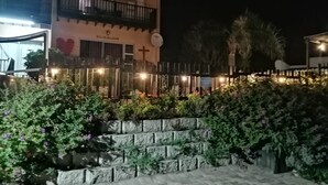 A building with a balcony, a heart-shaped decoration, and a cross. - BayView Guest House  (Jeffreys Bay)