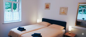 A double bed with two pillows, a bedside table with a lamp, and two framed pictures on the wall. - Wald Villa Üssbach- Your paradise between Cochem and Zell at the Moselle (Alf)