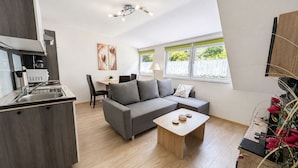 A modern apartment with a kitchen, dining area, and living room. - Wald Villa Üssbach- Your paradise between Cochem and Zell at the Moselle (Alf)