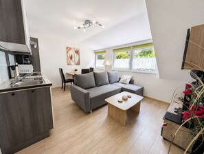 Eine moderne Wohnung mit Küche, Essbereich und Wohnzimmer.