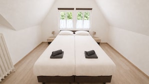 A twin bed room with two windows, a radiator, and a bedside table with a lamp. - Wald Villa Üssbach- Your paradise between Cochem and Zell at the Moselle (Alf)
