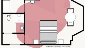 Ein Grundriss mit einem Bett, einem Schreibtisch, einem Stuhl, einer Toilette und einem Waschbecken.