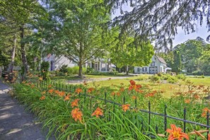 Ein Wohngebiet mit Häusern, einem Weg und einem Garten mit orangefarbenen Blumen.