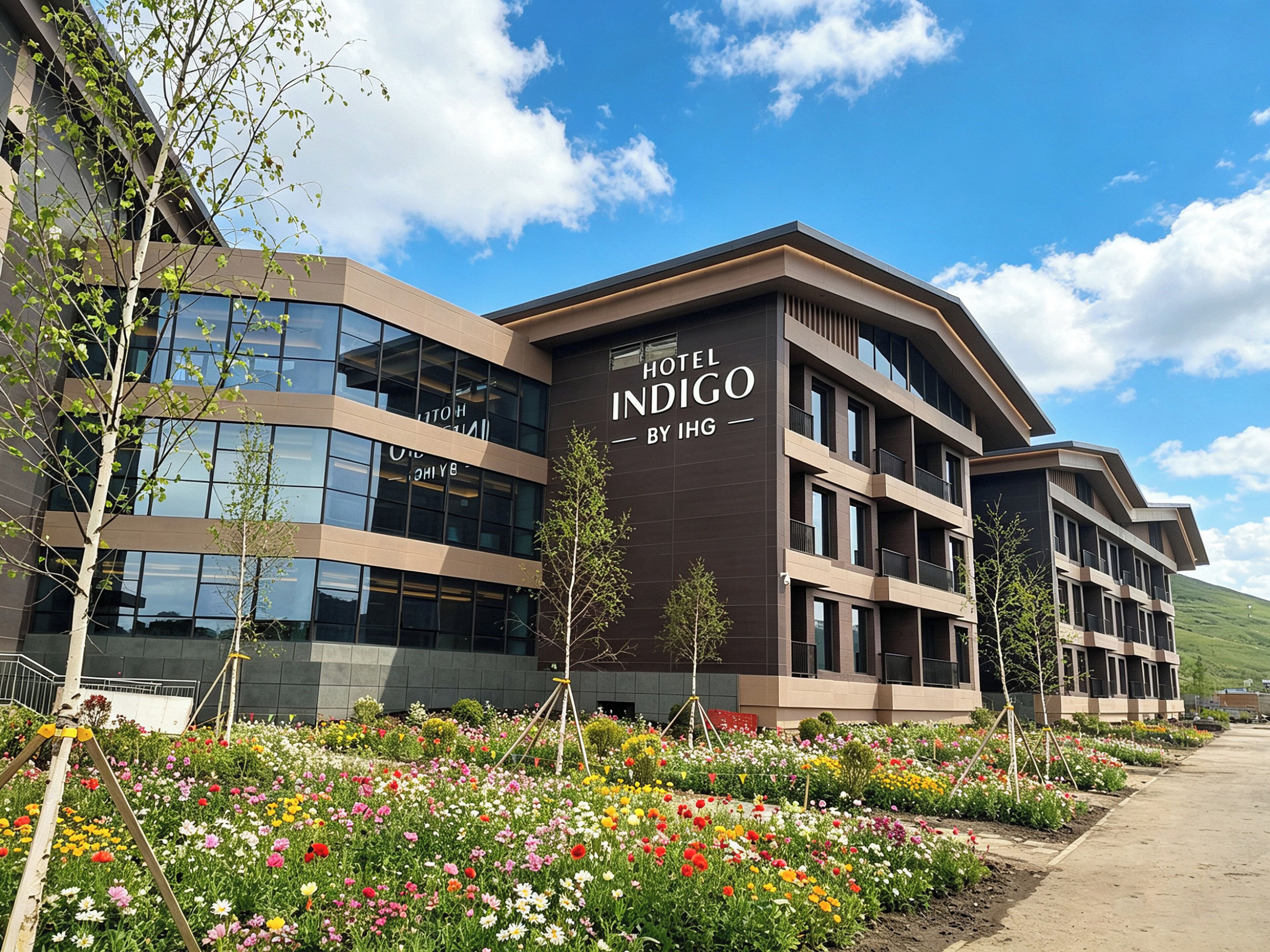 A modern hotel building with a sign reading 'Hotel Indigo by IHG.'