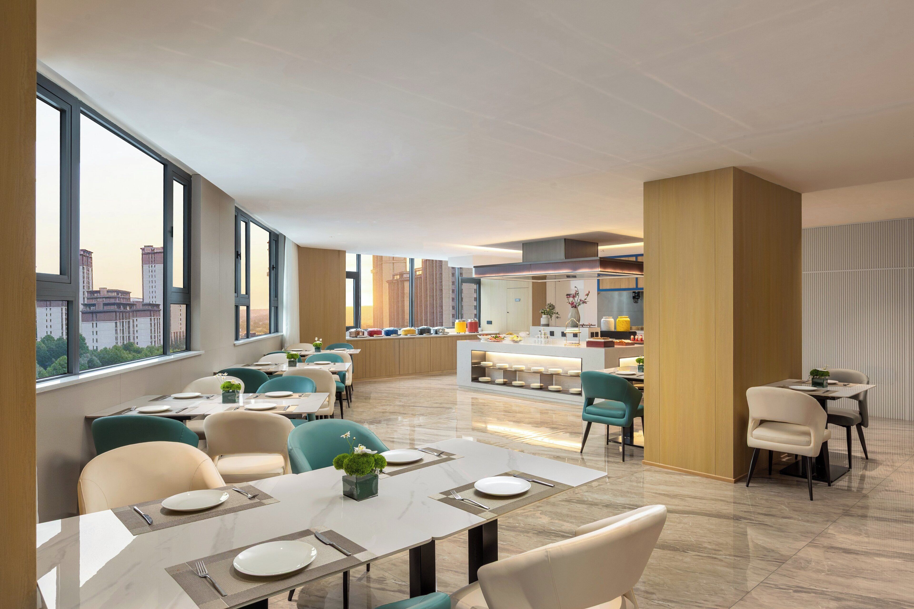 Un comedor moderno con techos altos, ventanas amplias y vistas a la ciudad.