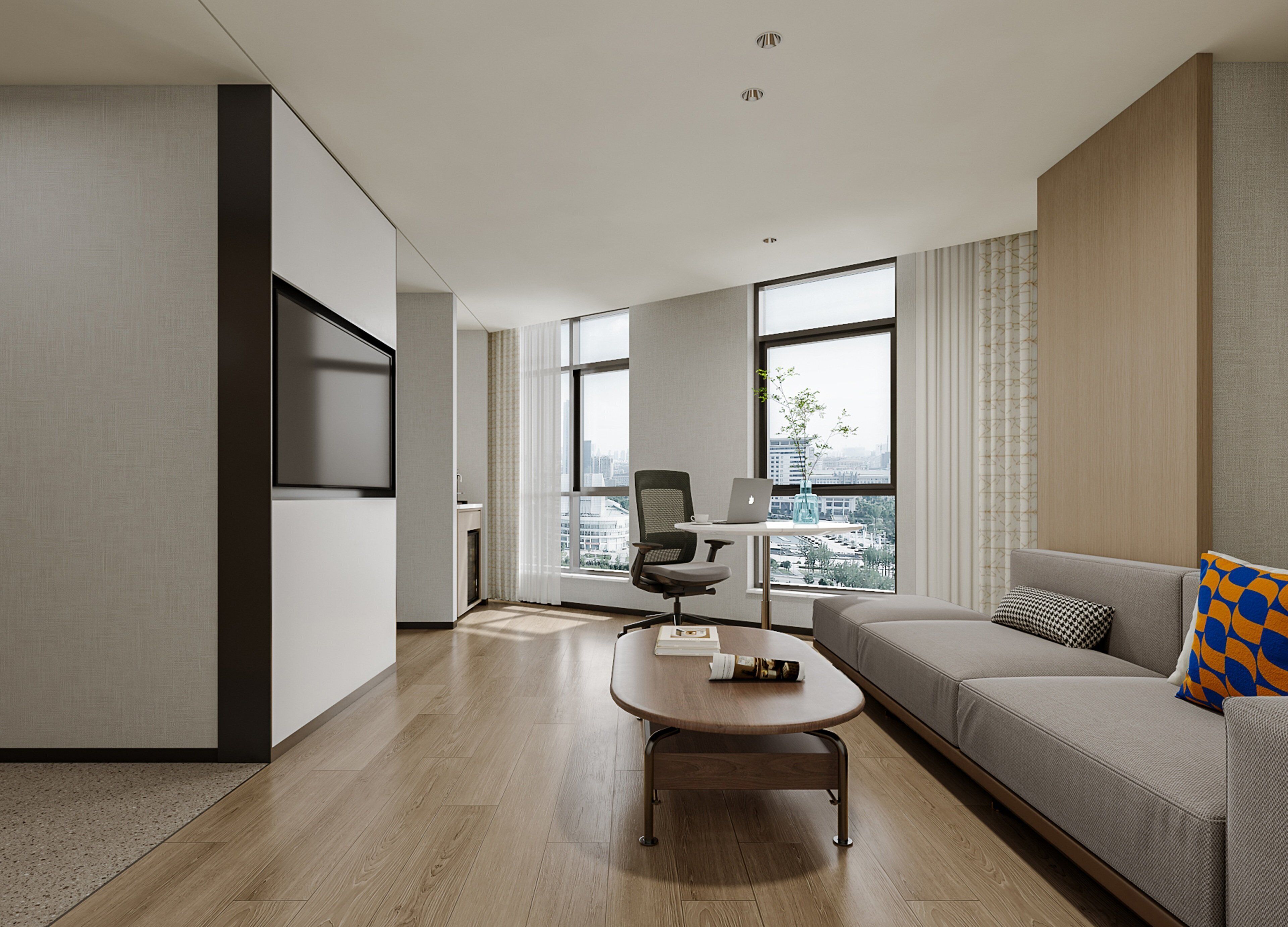 A modern living room with a sofa, a coffee table, and a desk with a laptop.