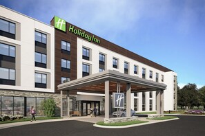 A Holiday Inn hotel with a modern facade, large windows, and a covered entrance area. - Holiday Inn Warner Robins South At Rigbys by IHG (Warner Robins)