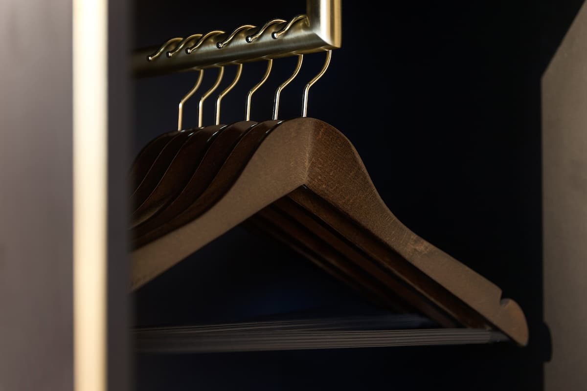 A wooden hanger with a metal rack.