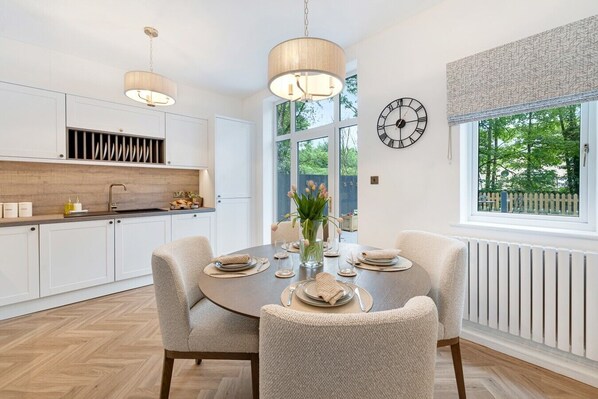 A modern kitchen with white cabinets, a wooden countertop, and pendant lighting. - NEW! Threadfold Townhouse - Peaceful Riverside Stay - Sleeps 6 (Bolton)