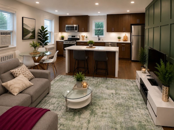 A modern kitchen with dark wooden cabinets, stainless steel appliances, and a central island with bar stools.