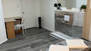 A room with a bed, a desk, a chair, a radiator, and a mirror. - Entire Private Suite! Free Parking! Comfortable Stay! Excellent Location! (Pickering)