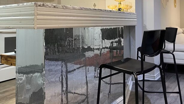 A modern kitchen with a central island, a wooden cabinet, and a decorative wall piece. - Entire Private Suite! Free Parking! Comfortable Stay! Excellent Location! (Pickering)