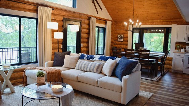 A log cabin interior with a living room, dining area, and kitchen. - Arla’s Pond Cottage - Scandinavian-Inspired Luxury in the Heart of Crosslake, MN (Crosslake)
