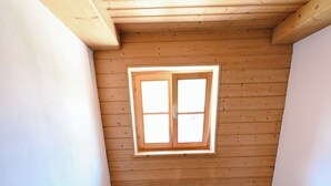 A staircase with wooden handrails and carpeted steps leading to a room with a sloped ceiling and a window. - Alpenvilla Liboria Wallgau: 220-square-meter vacation home with hobby room (Wallgau)