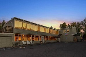 A two-story building with large windows, a garage, and outdoor seating. - Rm. 10, Queen, pet-friendly (Tahoe City)