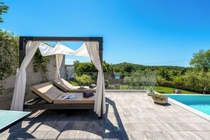 A private outdoor pool area with a canopy, lounge chairs, and a view of the surrounding greenery. - Villa with pool for 6 people, children's playground, darts, table tennis table (Dračevac)