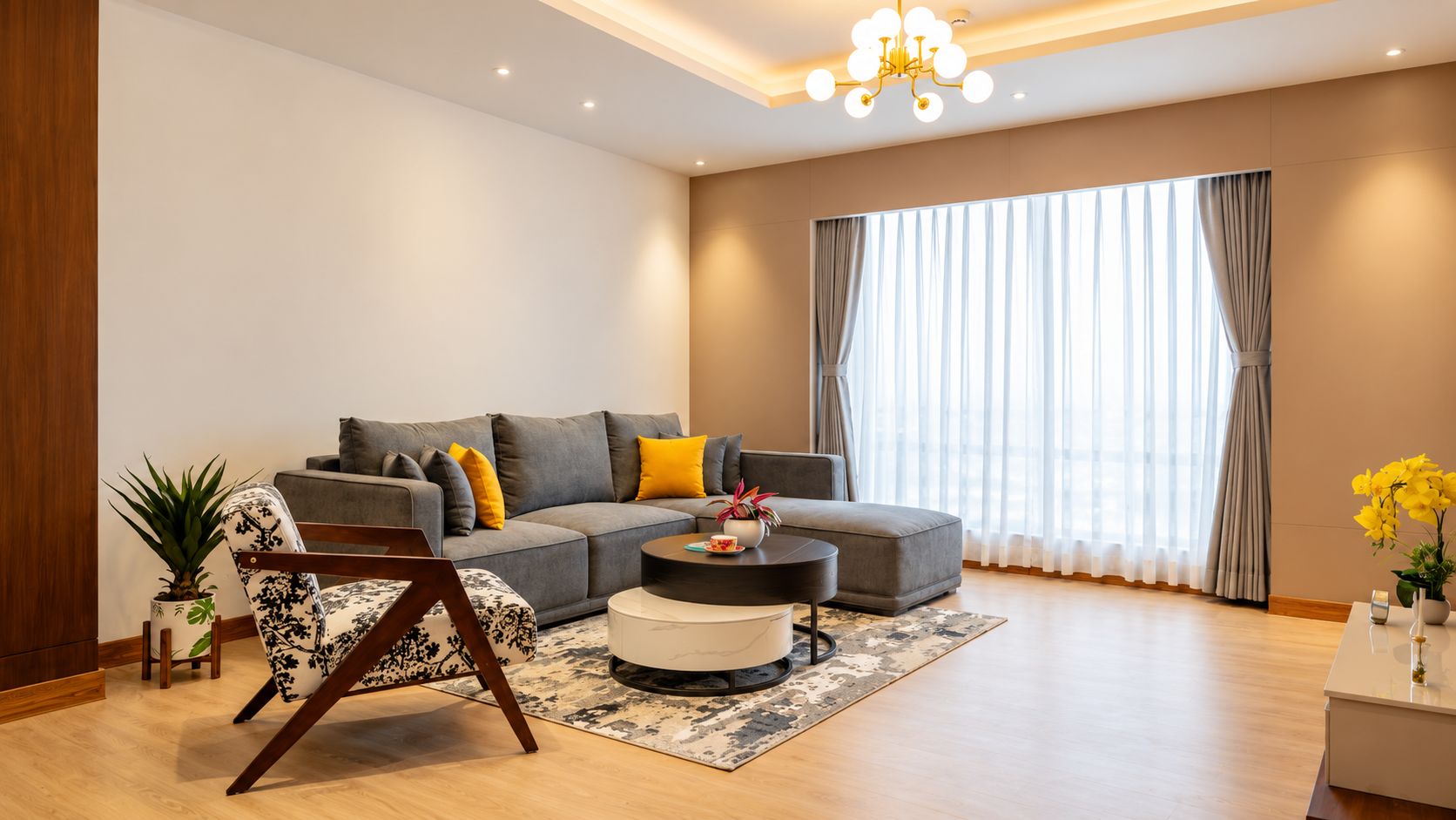 A modern living room with a sectional sofa, a round coffee table, and a potted plant.