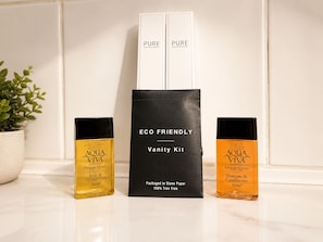 A bathroom vanity setup with a black vanity kit labeled 'ECO FRIENDLY' and two bottles of 'AQUA VIVA Orange Grove' bath and shower gel. - The Shed - Cosy 2-Bed Flat with Free Parking - Close to City Centre (Cardiff)