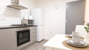 Eine moderne Küche mit Herd, Backofen, Mikrowelle und Kühlschrank.