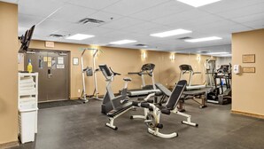 A gym with cardio machines, weight stations, and a water dispenser. - Golden Alpine Hideaway Studio Hot tub + Ski-in/out (Golden)